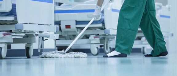 Epoxy Floor Coating Companies This image shows a man mopping the hospital floor.