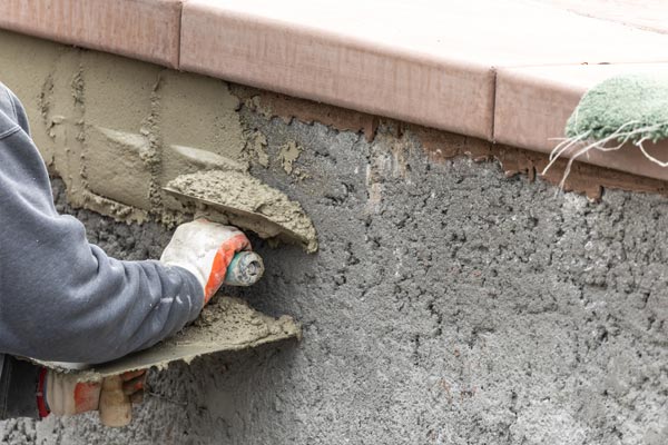 This shows an image of a man putting pool tiles.